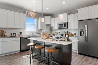 (Photo of decorated model, colors and features will vary) Welcome to the Bristol! This spacious kitchen features a large center island, quartz countertops, LVP floors, stainless appliances and more.