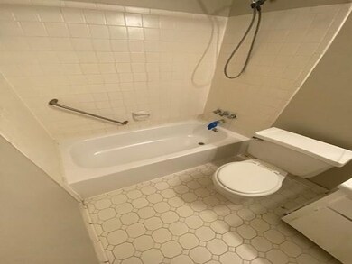Bathroom with tile patterned flooring, toilet, and