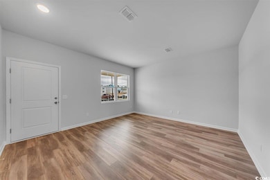 Unfurnished room featuring light wood-style floori