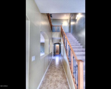 Hallway towards 1/2 bath, den & laundry