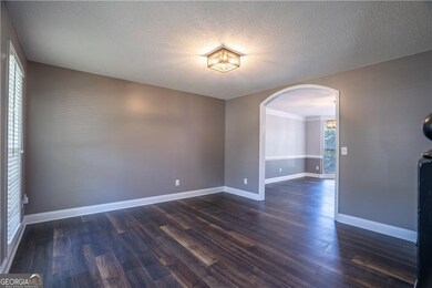 Office or formal living room featuring arched walkways,
