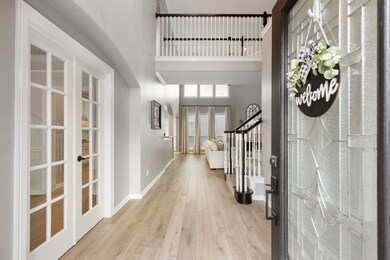 This inviting entryway features a glass-paneled fr