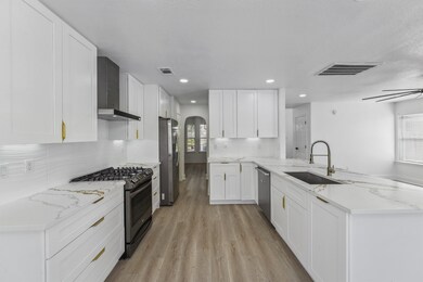 Highlighting sleek quartz countertops, stainless s