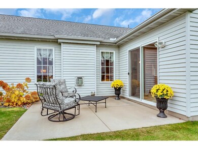 Rear concrete patio off sun room.