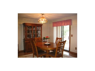 Formal dining room with laminate flooring.