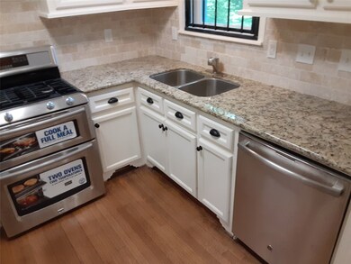 Remodeled Kitchen includes Hardwoods , Granite Countertops and New Stainless Appliances!Gorgeous tile backsplash!