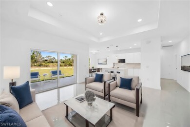 Tiled living room featuring a raised ceiling