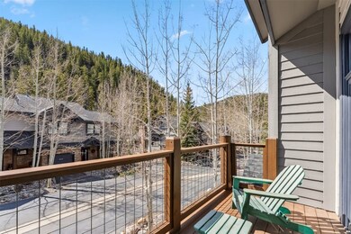Balcony featuring a mountain view and a wooded vie