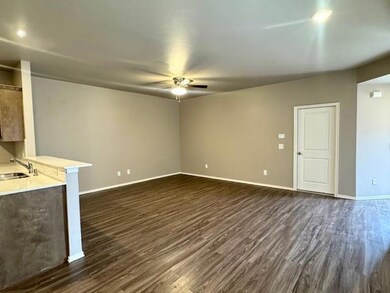 Unfurnished living room featuring dark wood finish