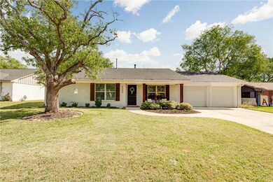 Ranch-style house with a front yard, brick siding,