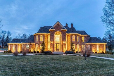 Twilight view of this elegant home with circle drive.