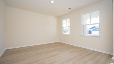 Empty room with baseboards, light wood-type floori