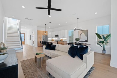 Living room with visible vents, light wood-style 
