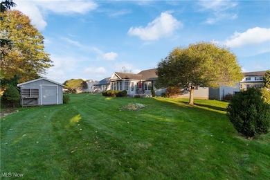 Oversized shed for lawn and gardening tools.