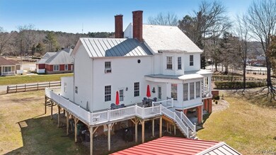 Back of house with a lawn and a wooden deck