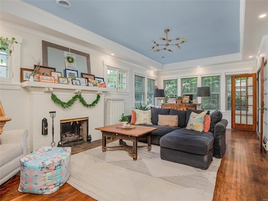 Nine-foot ceilings with accent color and recessed lights in the soffit, white-washed walls and attractive fireplace make this room very inviting.