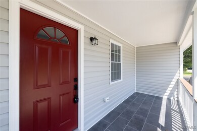 View of exterior entry featuring a porch