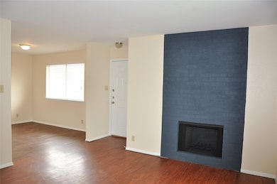Unfurnished living room with wood finished floors