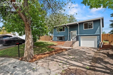 Freshly landscaped w/ brand new garage door.