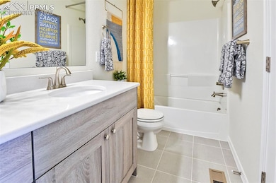 Full bath featuring vanity, shower / tub combo, and light tile patterned floors