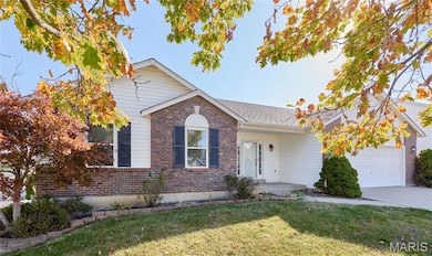 Ranch-style house with brick siding, a front lawn, a garage, and concrete driveway