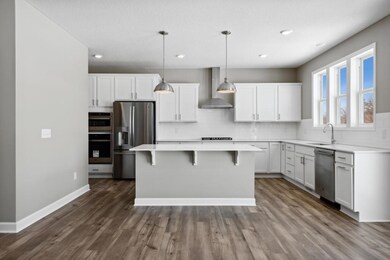 (Photo of an inventory home, actual homes finishes will vary) The gourmet kitchen includes a large center island, quartz countertops, LVP floors, stainless appliances and more!