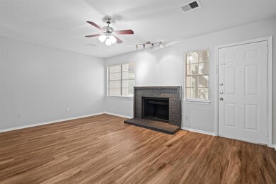 Unfurnished living room featuring ceiling fan, wo