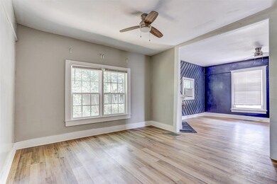 Unfurnished room with ceiling fan and light wood finished floors