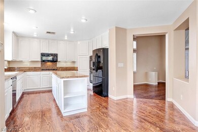 Large kitchen island with granite counters and dou