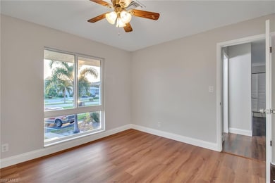 Empty room featuring ceiling fan and hardwood / wo
