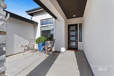 Entrance to property featuring stucco siding and a patio