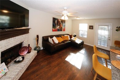 Living room featuring a fireplace, a textured ceil