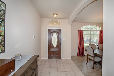 To the right, an elegant arched doorway leads into