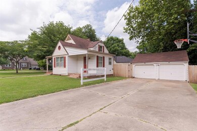 View of front facade featuring a front yard, an ou