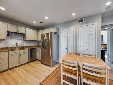Kitchen with backsplash, light hardwood / wood-sty