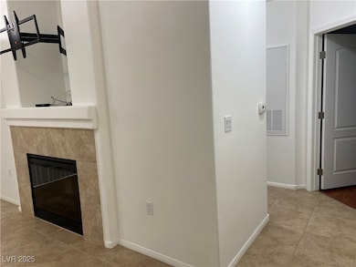 Hall with baseboards and light tile patterned floo