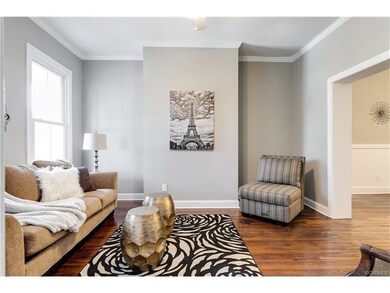 LR with ceiling fan, pine floors, crown molding an
