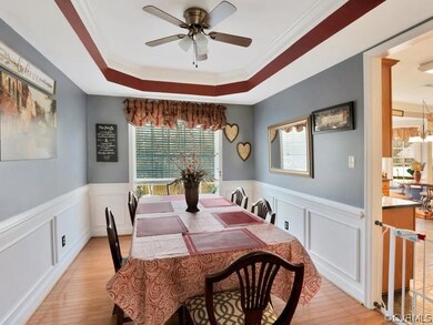 Dining Room has hardwood floors, tray ceiling with