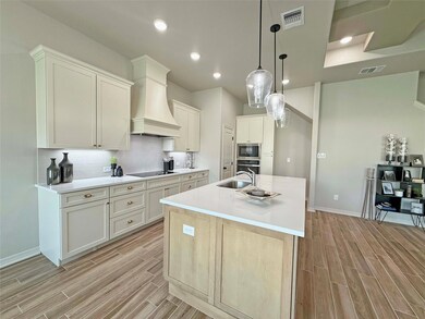 Kitchen with built in microwave, visible vents, an