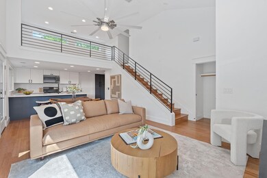 Living area with stairs, recessed lighting, high 