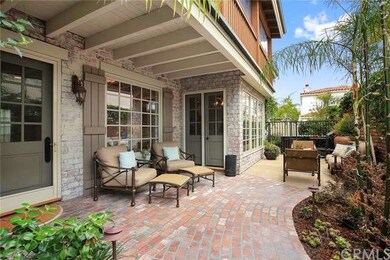 Front entry with brick pavers and sitting areas.