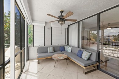 Sunroom with ceiling fan and a patio area