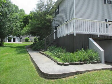 Walk leading to 9x9 storm shelter and back deck.
