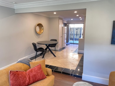 Corridor with recessed lighting, ornamental molding, and light wood-style floors