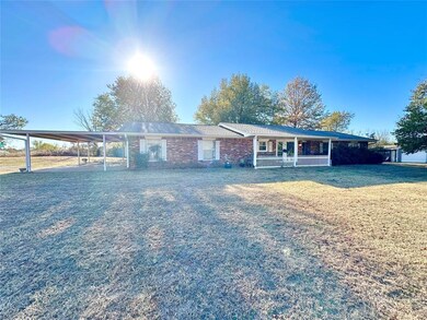 Single story home featuring a carport, a front yar