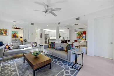 Living room with ceiling fan and light hardwood / 