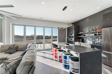 Kitchen featuring a kitchen island with sink, hang