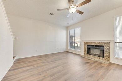 Unfurnished living room featuring ceiling fan, a t