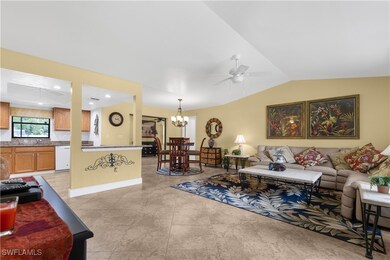 Living room featuring lofted ceiling, a ceiling fa