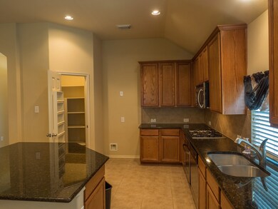 Open the lighted walk-in pantry.  Get ready to cook!  From here you can see so many areas of the home.  The formal dining room is a quick trip through the entry providing easy access for serving meals.
